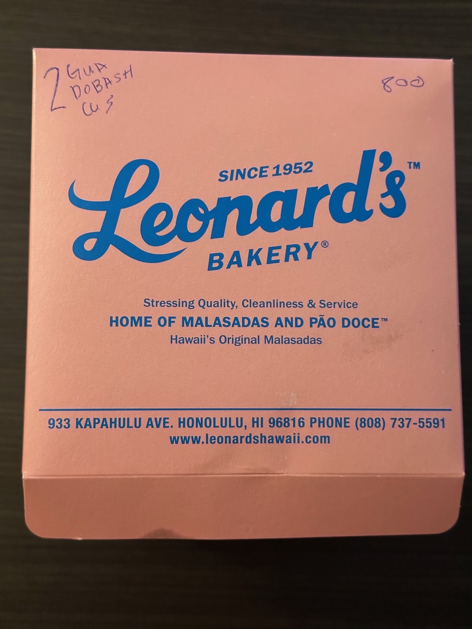 Photo of a pink box with &quot;Leonard&#39;s Bakery (since 1952)&quot; written in blue letters.