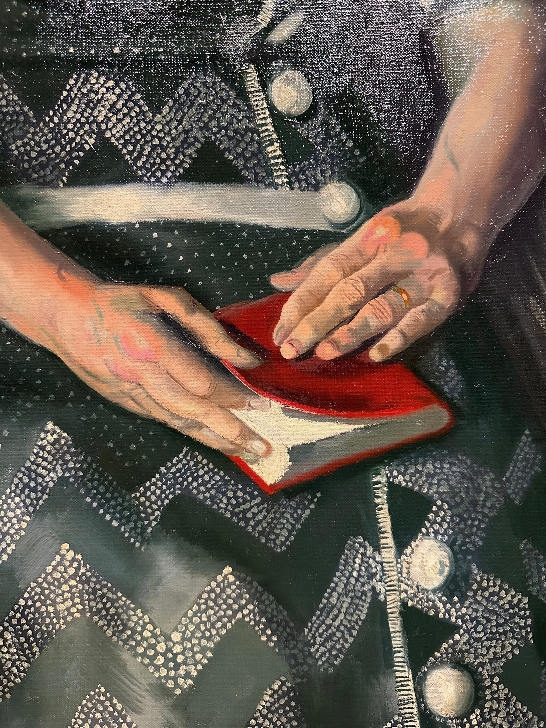 Close-up of Mrs. Wase&#39;s hands holding a book. Fingers look swollen and misshapen in places.