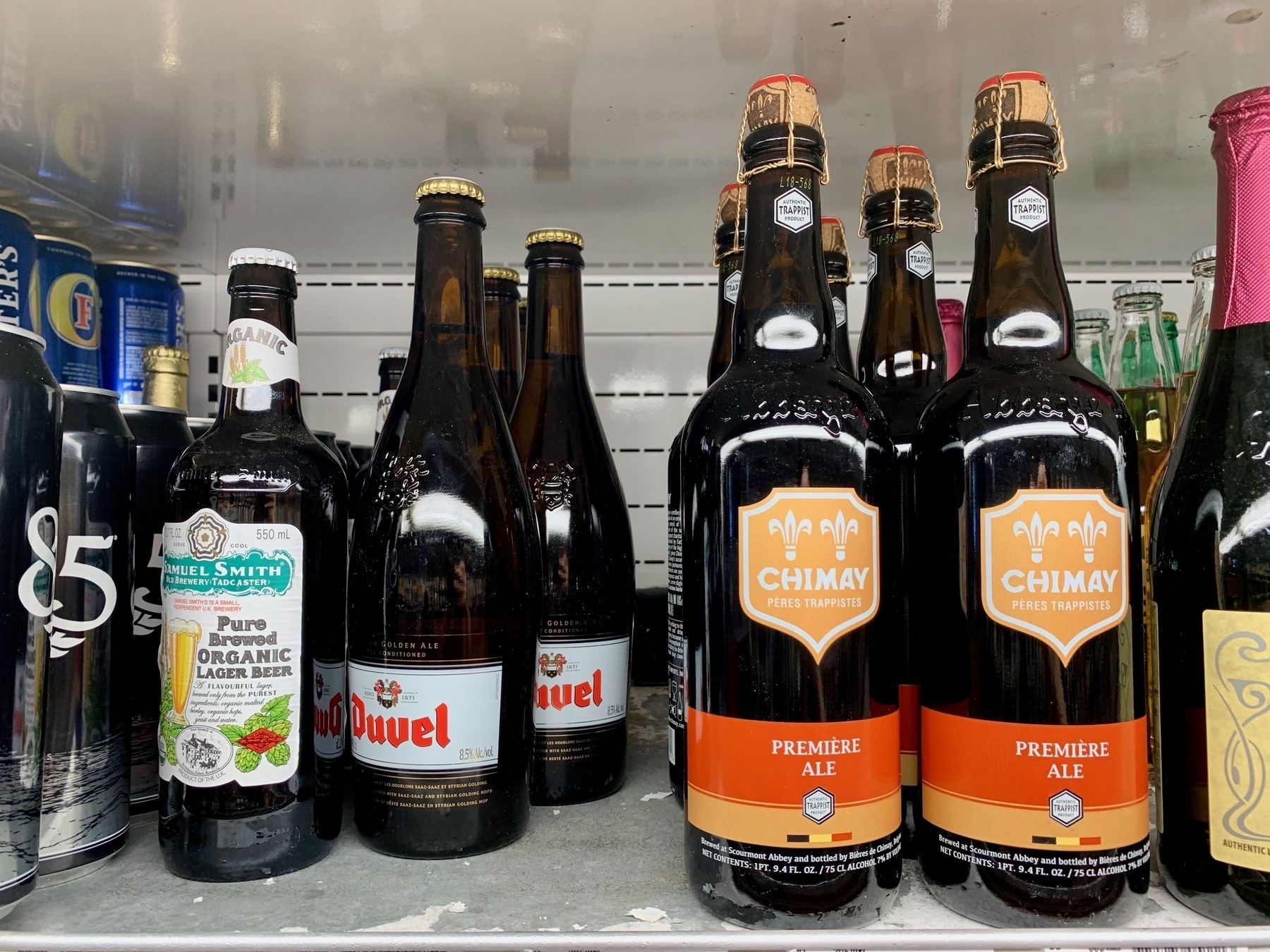 Photo of belgian beers on a grocery store shelf.
