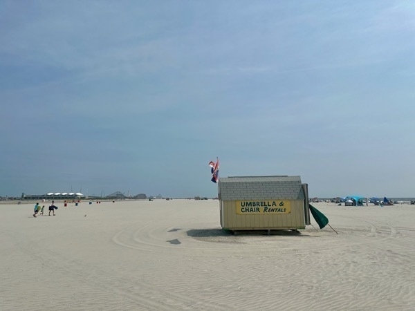 Photo of a white sand beach that stretches for hundreds of yards across.