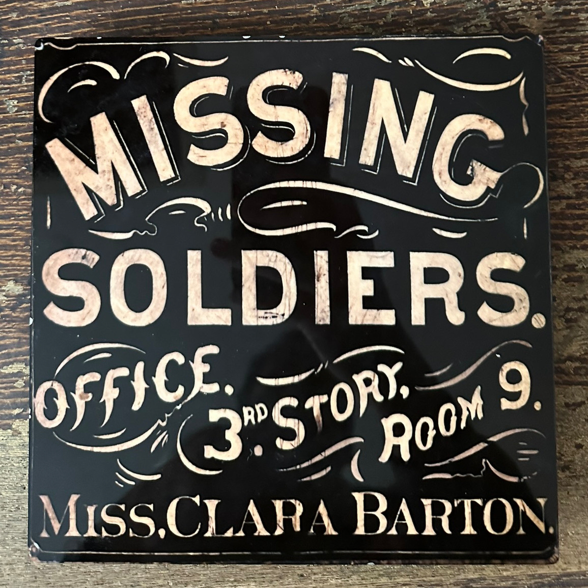 Plaque with ornate all-capital letters saying Missing Soliders Office, 3rd story, room 9, Miss Clara Barton.